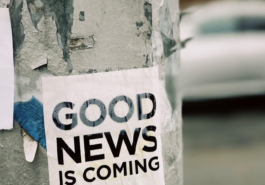 white Good News Is Coming paper on wall
